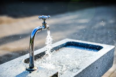 water pouring out of an outdoor spigot